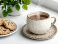 A cup of tea and chocolate chip cookies on a white table Royalty Free Stock Photo