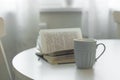 A cup of tea or coffee, open book on a white table. The concept of cozy, mood and home comfort Royalty Free Stock Photo