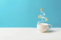 Cup of tea or coffee with steam in fir tree shape with gingerbread cookies on blue background. Christmas celebration concept. Copy