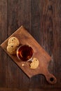 Cup of tea with cookies on a cutting board on a wooden background, top view, vertical Royalty Free Stock Photo