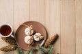 A cup of hot tea with Christmas gingerbread, a branch of a spruce tree on a wooden background Royalty Free Stock Photo