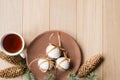 A cup of hot tea with Christmas gingerbread, a branch of a spruce tree on a wooden background Royalty Free Stock Photo