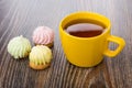 Cup of tea and cookies with souffle and coconut flakes