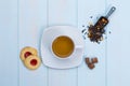 Cup of tea with cookies, sugar and loose leaves Royalty Free Stock Photo