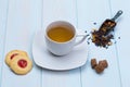 Cup of tea with cookies, sugar and loose leaves Royalty Free Stock Photo