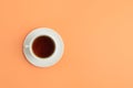 Cup of tea on coral background, top view Royalty Free Stock Photo