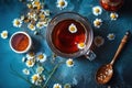 Cup of tea with daisies, chamomile and honey and spoons, top view, blue background. Royalty Free Stock Photo