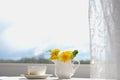 Cup of tea, dandelion flowers and phone. Spring morning. Royalty Free Stock Photo