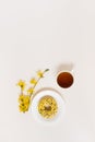 Cup of tea and donut on a plate, yellow flowers. Tea break. Copy space and flat lay Royalty Free Stock Photo