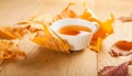 A cup of tea with falling autumn leaves of maple on the background of the wood table Royalty Free Stock Photo