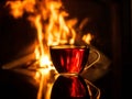 Cup of tea by the fireplace. fire background Royalty Free Stock Photo
