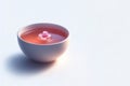 A cup of tea with a floating flower. Space for text. Royalty Free Stock Photo