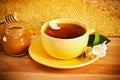 Cup of tea with flower of a jasmin and honey Royalty Free Stock Photo