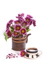 Cup of tea and flowers in a teapot