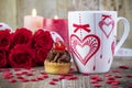 Cup of tea in front of bouquet of red roses Royalty Free Stock Photo