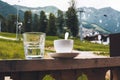 Cup of tea and a glass of water on a terrace on the porch curb against the backdrop mountains ski resort Royalty Free Stock Photo
