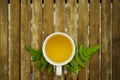 A cup of tea with green leaf on wooden table Royalty Free Stock Photo