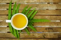 A cup of tea with green leaf on wooden table in the garden Royalty Free Stock Photo