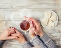 A cup of tea in the hands of a man and a woman. Royalty Free Stock Photo