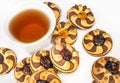 Cup of tea and heap of cookies with jam on white wooden table. Top view Royalty Free Stock Photo