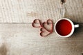 Cup of tea with heart shape on vintage wooden table, minimal concept of valentine mother day morning breakfast