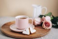 A cup of tea, heart-shaped cookies, pink roses and jug with milk on a wooden tray. Valentines day concept. Morning Royalty Free Stock Photo