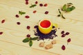 Cup of tea with hip roses, on wooden table. A cup made of real lemon Royalty Free Stock Photo