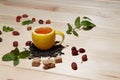 Cup of tea with hip roses, on wooden table. A cup made of real lemon Royalty Free Stock Photo