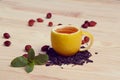 Cup of tea with hip roses, on wooden table. A cup made of real lemon Royalty Free Stock Photo