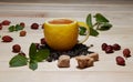 Cup of tea with hip roses, on wooden table. A cup made of real lemon Royalty Free Stock Photo