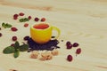 Cup of tea with hip roses, on wooden table. A cup made of real lemon Royalty Free Stock Photo