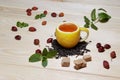 Cup of tea with hip roses, on wooden table. A cup made of real lemon Royalty Free Stock Photo