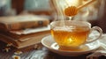 A cup of tea with honey being poured Royalty Free Stock Photo