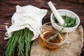 cup of tea from horsetail, made from fresh potion, from pharmacy mortar. Horsetail infusions are used as a diuretic for