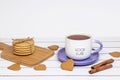 A cup of tea with the inscription good luck and a stack of crispy cookies on a wooden cutting board