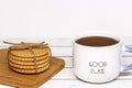 A cup of tea with the inscription good luck and a stack of crispy cookies on a wooden cutting board. Close-up