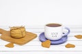 A cup of tea with the inscription good luck and a stack of crispy cookies on a wooden cutting board