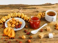 A Cup of tea, jam, bagels and sweets on a wooden table. Cozy tea party atmosphere in autumn or winter with copy space Royalty Free Stock Photo