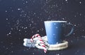 Cup of tea on knitted mittens. Christmas background. Hyugge style. Close-up