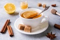 Cup of tea with lemon and brown sugar, cinnamon and anise on the table Royalty Free Stock Photo
