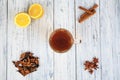 Cup of tea, lemon, cinnamon, cloves, dried tea leaves