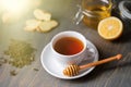 Cup of tea with lemon, ginger, honey and honey stick on wooden rustic table Royalty Free Stock Photo