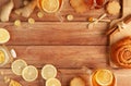 Cup of tea with lemon, honey, ginger root ingredients and sweet cinnamon bun on wooden table. Natural medicine concept Royalty Free Stock Photo