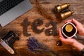 The word `tea` spelled using brown wooden letters on the wooden table. Royalty Free Stock Photo