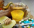 Cup of tea with lemon, pills, a thermometer and a warm scarf. vitamin tea. cold and flu remedy. Royalty Free Stock Photo