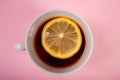 Cup of tea with lemon on a pink background Royalty Free Stock Photo