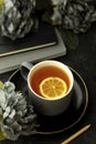 Cup of tea with lemon slice, dark background