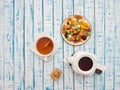 Cup of tea with lemon, a teapot and dried fruits on a wooden table Royalty Free Stock Photo