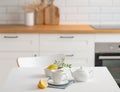 A cup of tea with lemon and a teapot on a white table Royalty Free Stock Photo