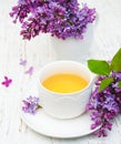 Cup of tea and lilac flowers Royalty Free Stock Photo